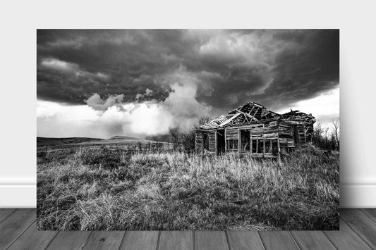 Black and white aluminum metal print of an abandoned homestead and passing thunderstorm on a stormy spring day on the Kansas prairie by Sean Ramsey of Southern Plains Photography.