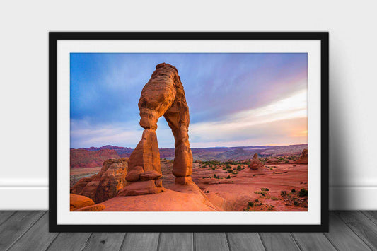 Framed and matted desert landscape print of Delicate Arch glowing in warm sunlight after a rainy evening in Arches National Park near Moab, Utah by Sean Ramsey of Southern Plains Photography.