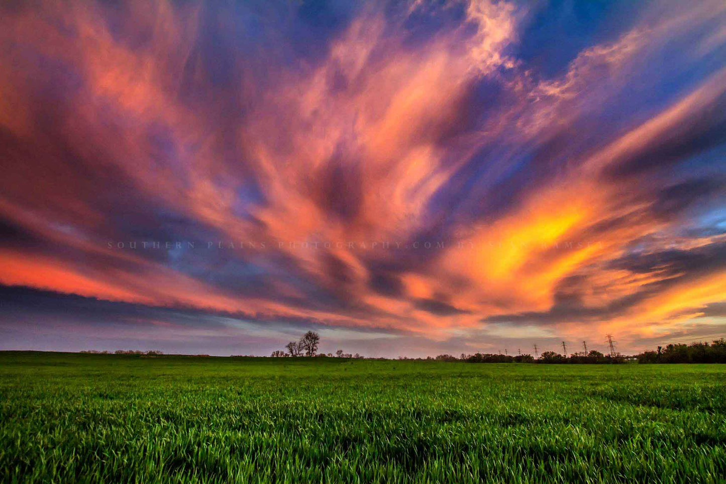 Nature photography print of clouds illuminated by sunlight over a field at sunset on a spring evening in Oklahoma by Sean Ramsey of Southern Plains Photography.