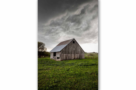 Vertical country photography print of an old weathered barn underneath storm clouds on a stormy spring day in Texas by Sean Ramsey of Southern Plains Photography.