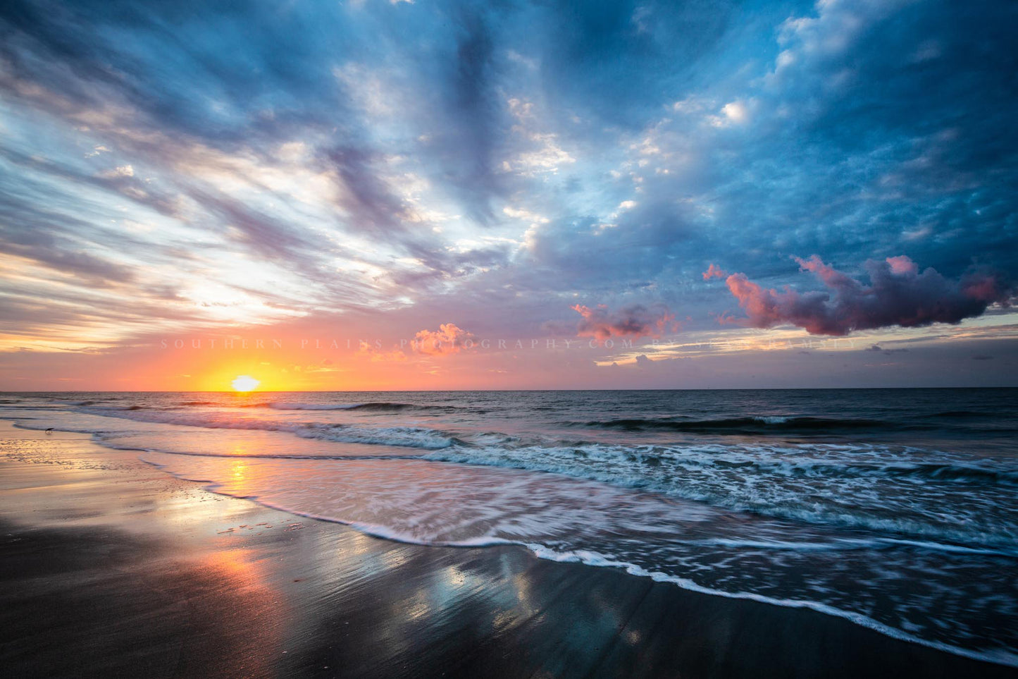Coastal photography print of a scenic sunrise over the Atlantic Ocean as waves roll ashore on a beach on Hilton Head Island, SC by Sean Ramsey of Southern Plains Photography.