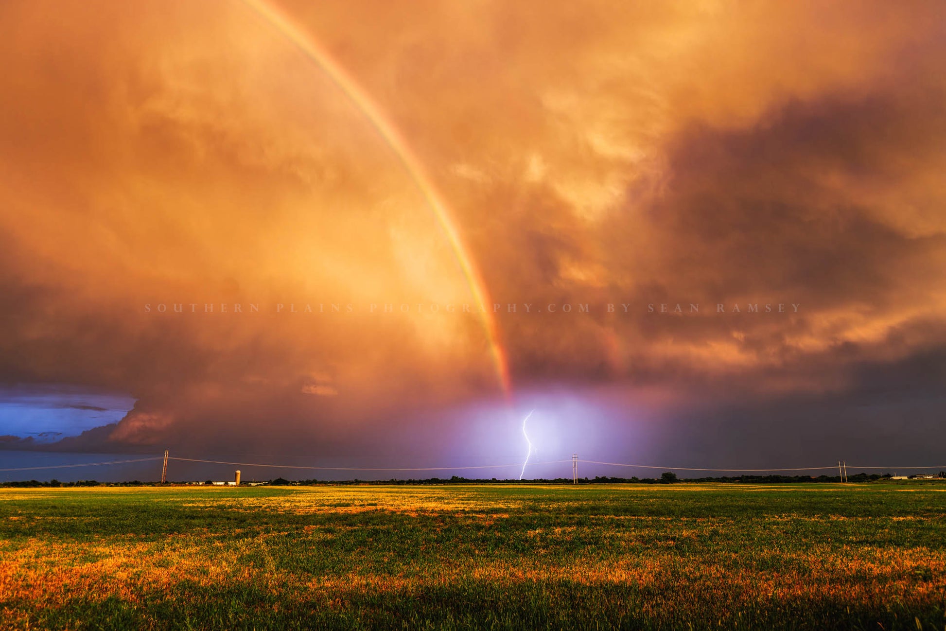 Stormy sky photography print of lightning illuminating the end of a vibrant rainbow at sunset on a stormy summer evening in Oklahoma by Sean Ramsey of Southern Plains Photography.