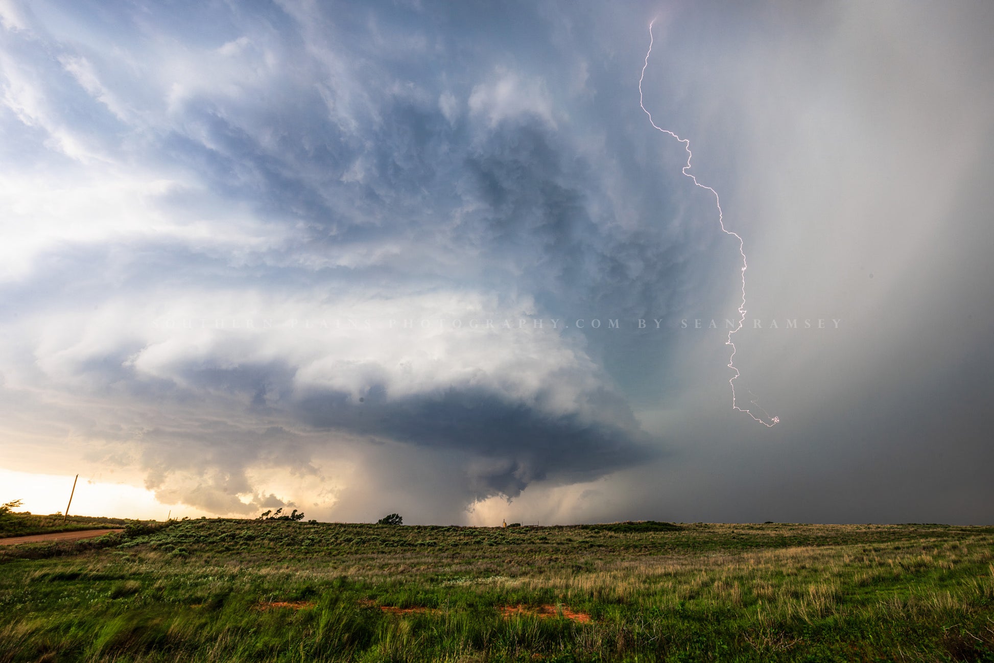 Storm photography print of a supercell thunderstorm with lightning bolt bringing drama to the sky on a stormy spring day in Oklahoma by Sean Ramsey of Southern Plains Photography.