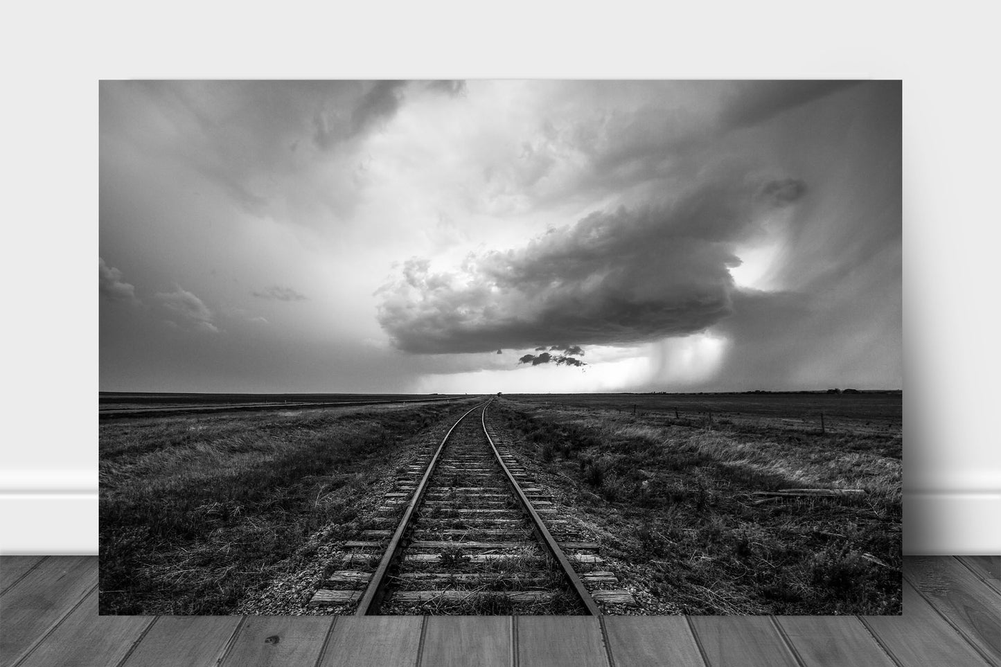 Wanderlust metal print of railroad tracks leading to a distant storm cloud on a stormy spring day on the plains of Kansas by Sean Ramsey of Southern Plains Photography.