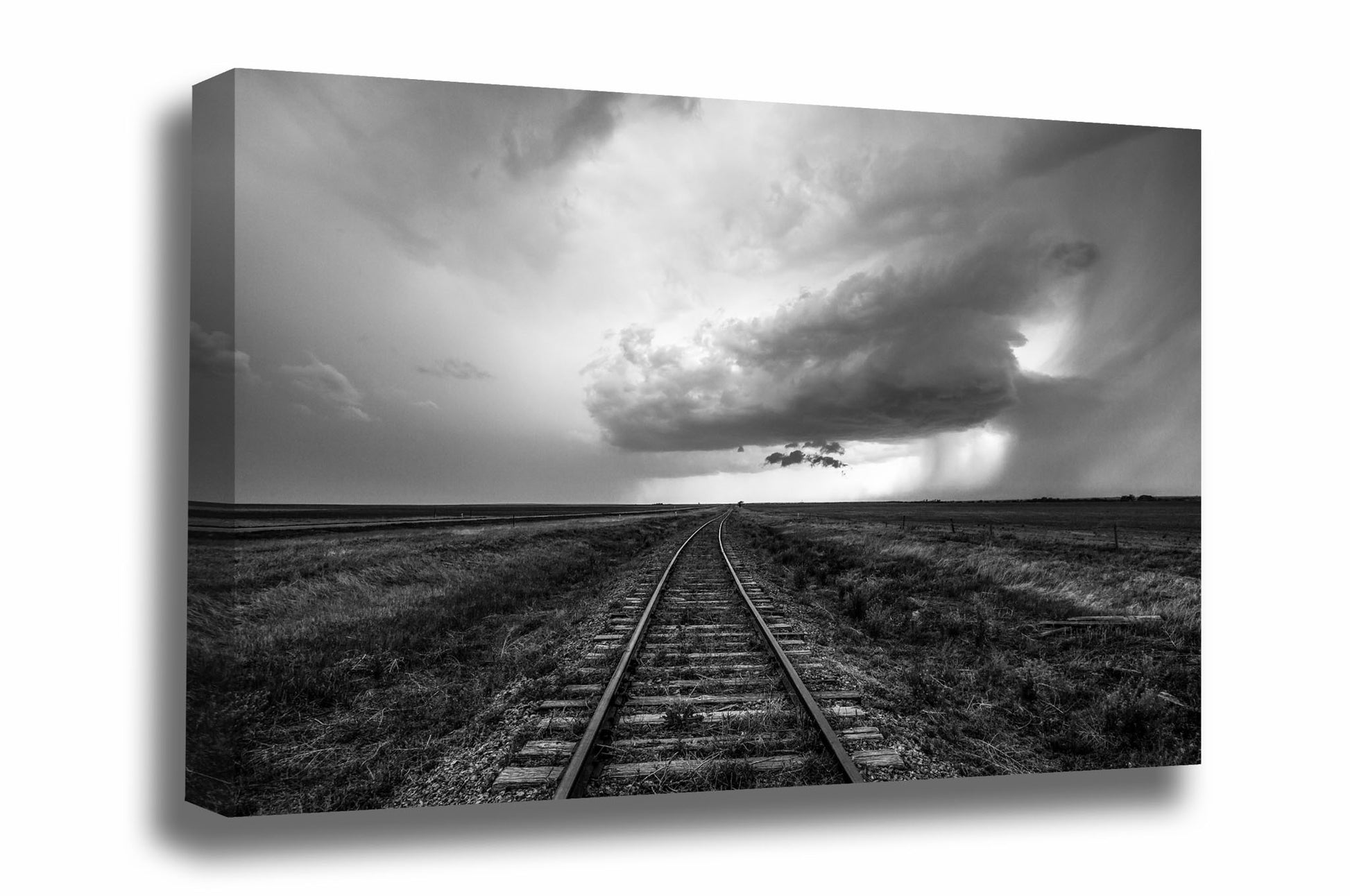 Black and white  wanderlust canvas wall art of railroad tracks leading to a distant storm cloud on a stormy day on the plains of Kansas by Sean Ramsey of Southern Plains Photography.