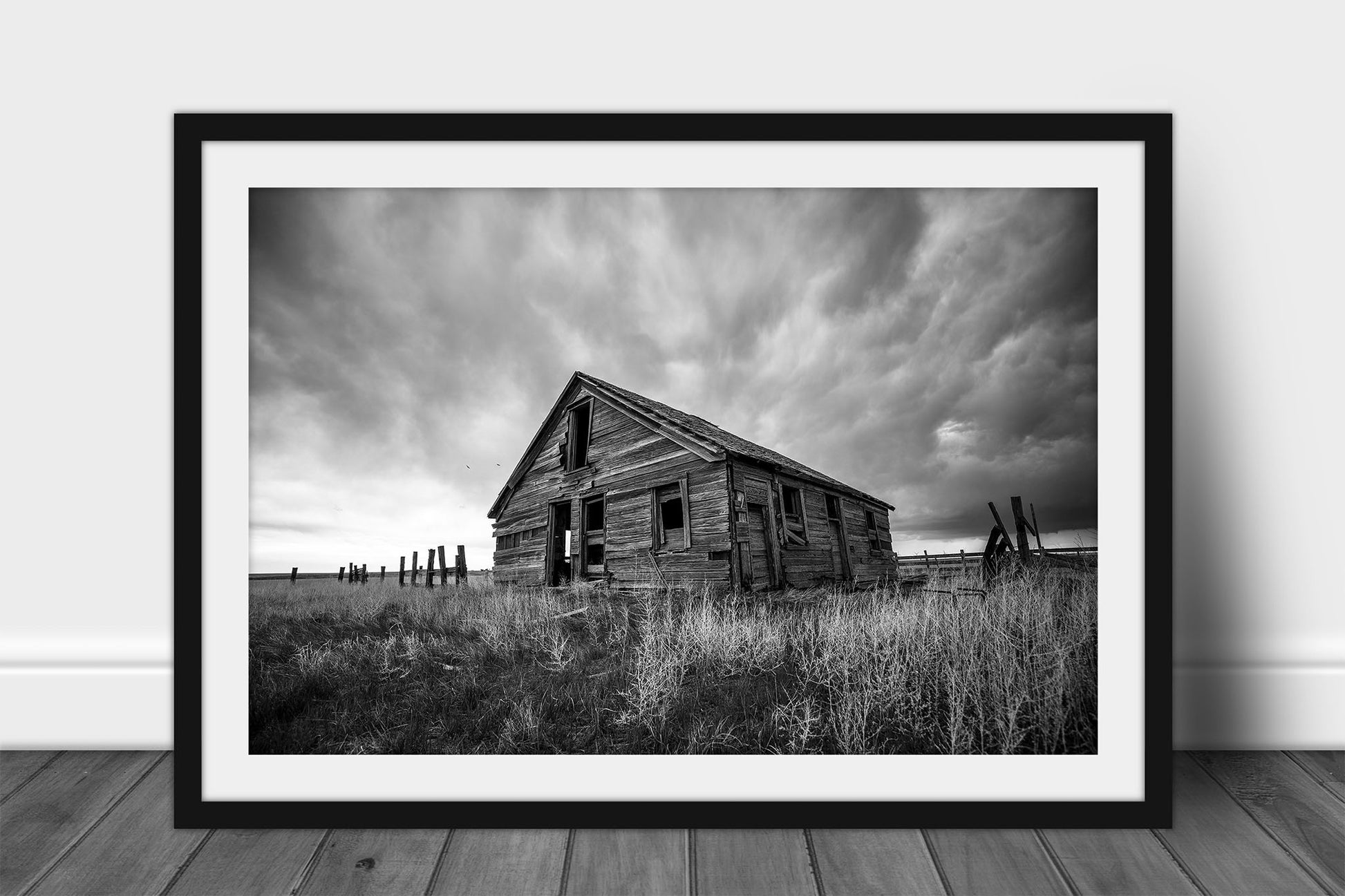 Framed and matted  black and white Great Plains print of a rustic abandoned homestead on a stormy day on the Colorado prairie by Sean Ramsey of Southern Plains Photography.
