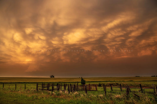 Great Plains photography print of a stormy sky glowing orange in evening sunlight over a fence at sunset on a spring evening in Oklahoma by Sean Ramsey of Southern Plains Photography.