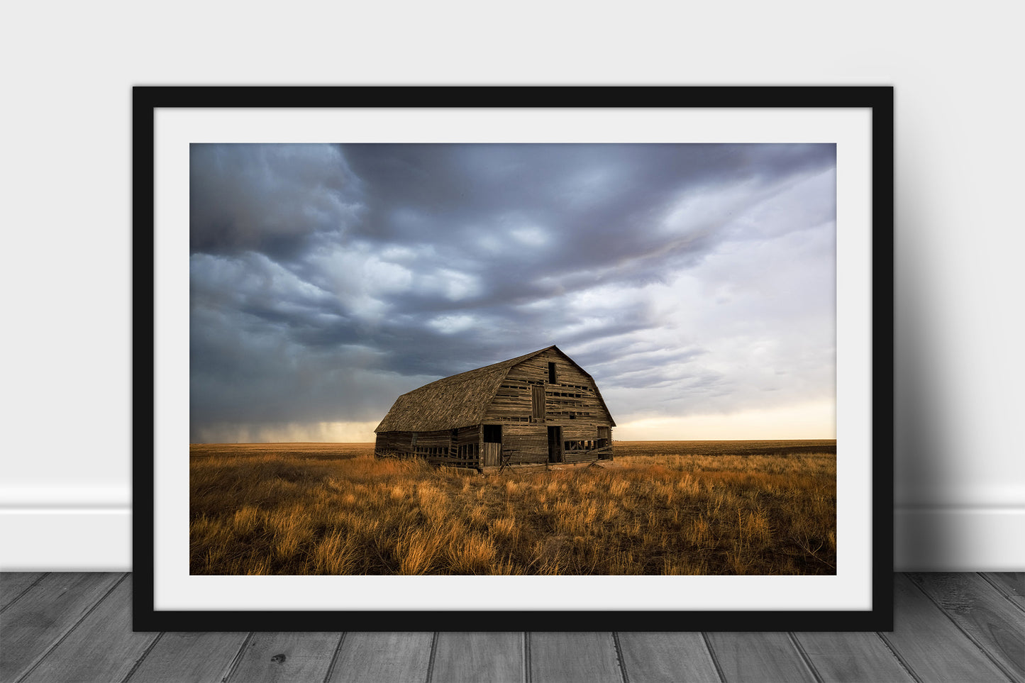 Framed and matted Great Plains print of an old wooden barn standing alone in prairie grass under a stormy sky in Oklahoma by Sean Ramsey of Southern Plains Photography.