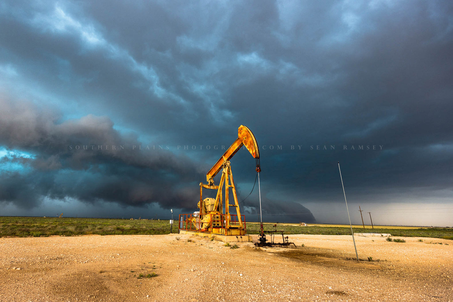 Oilfield photography print of a storm approaching a rusty pump jack on a stormy day in the Permian Basin in West Texas by Sean Ramsey of Southern Plains Photography.