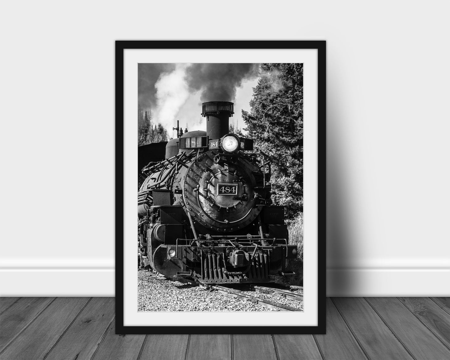 Vertical black and white train framed print of a vintage style steam engine rolling down the tracks along a railroad in the mountains of Colorado by Sean Ramsey of Southern Plains Photography.