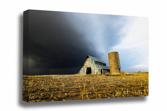 Country canvas wall art of a storm approaching an old barn and grain silo on a stormy spring day in Kansas by Sean Ramsey of Southern Plains Photography.