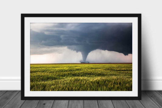 Framed and matted storm photography print of a large tornado passing behind a farmhouse in a wheat field on a stormy spring day in Kansas by Sean Ramsey of Southern Plains Photography.