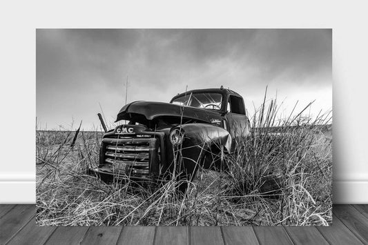 Black and white vintage style metal print on aluminum of an abandoned classic pickup truck in a field on a rainy day in Oklahoma by Sean Ramsey of Southern Plains Photography.