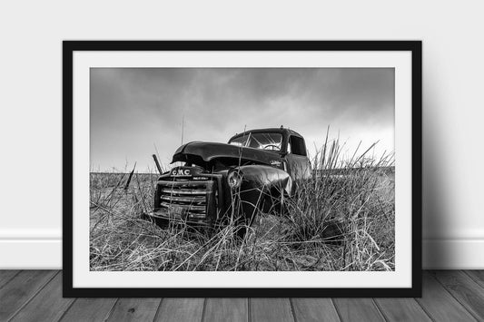 Framed and matted black and white vintage style print of an abandoned classic pickup truck in a field on a rainy day in Oklahoma by Sean Ramsey of Southern Plains Photography.