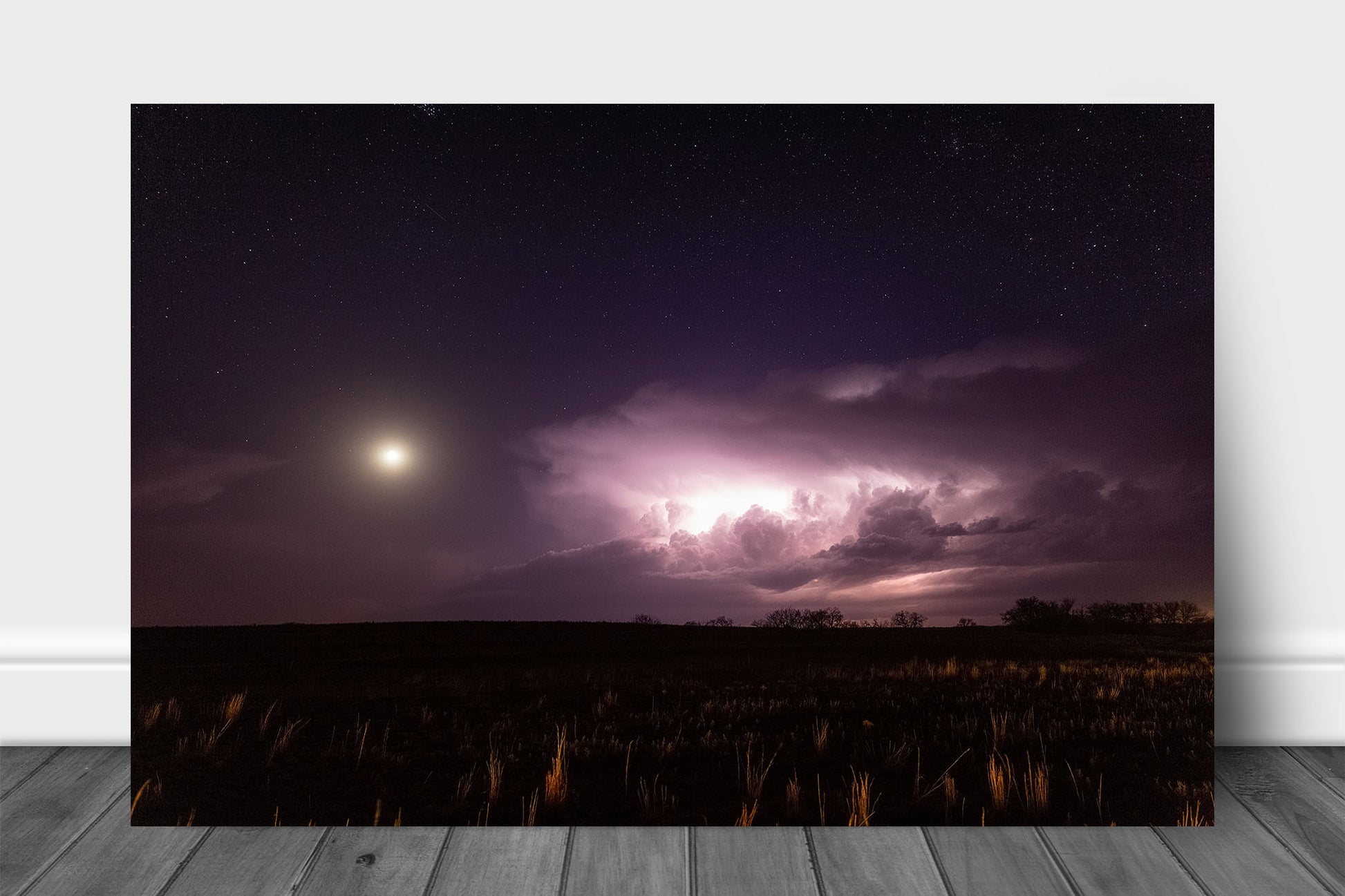 Storm aluminum metal print wall art of a supercell thunderstorm illuminated by lightning as a full moon shines bright in a starry night sky in Oklahoma by Sean Ramsey of Southern Plains Photography.