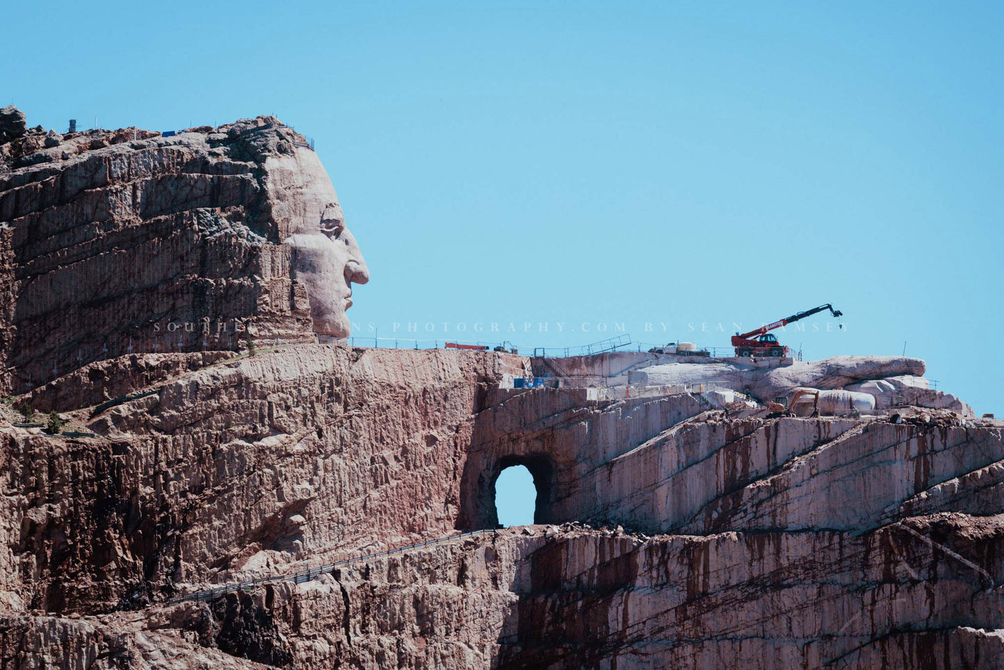 Black Hills photography print of the Crazy Horse Memorial on a blue sky day in South Dakota by Sean Ramsey of Southern Plains Photography.