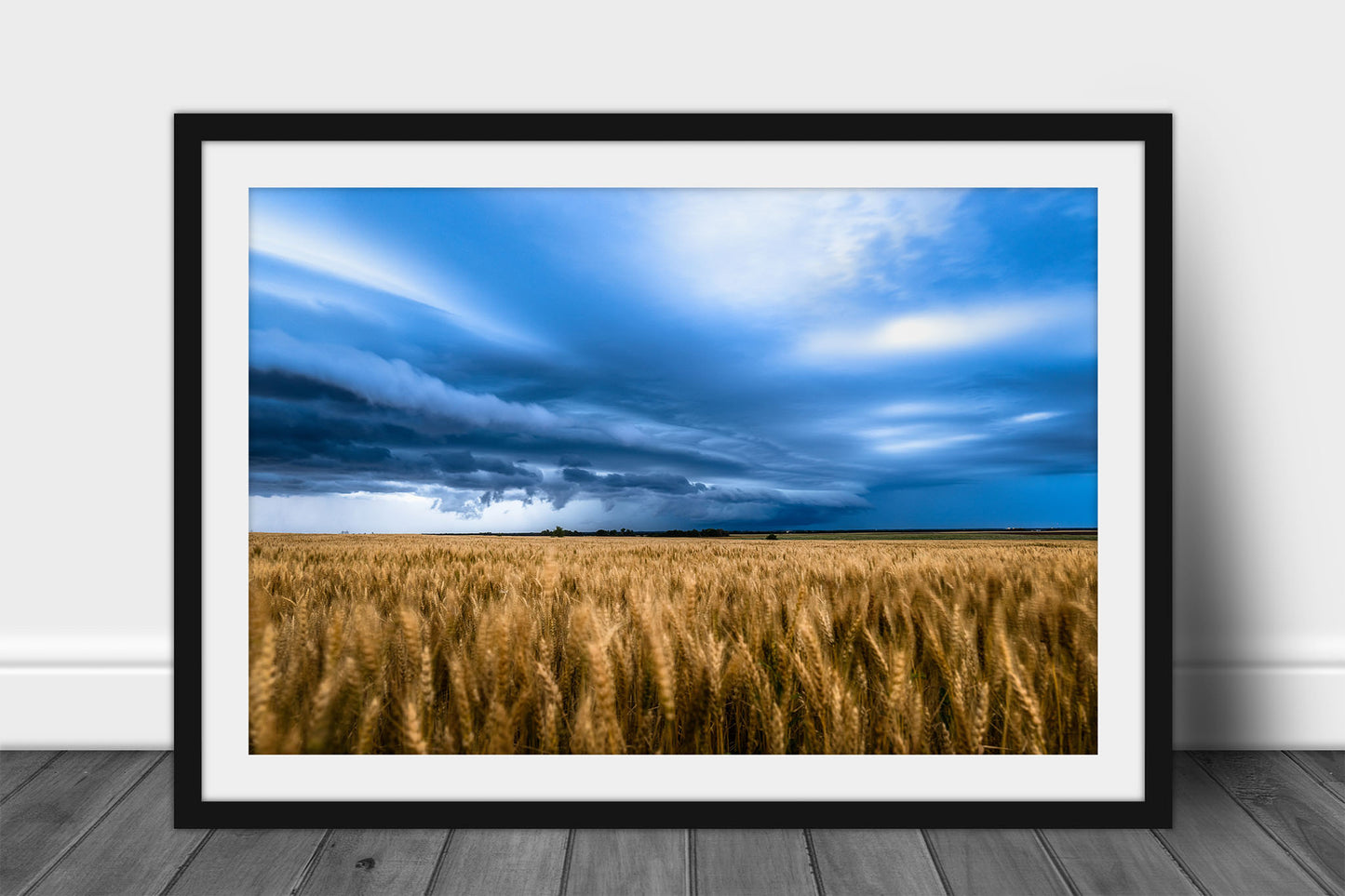 Framed and matted Great Plains print of a thunderstorm advancing over a golden wheat field on a stormy spring evening in Kansas by Sean Ramsey of Southern Plains Photography.