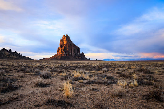 Southwestern landscape photography print of Shiprock glowing in evening light at sunset in the Navajo lands near the Four Corners region of New Mexico by Sean Ramsey of Southern Plains Photography. 