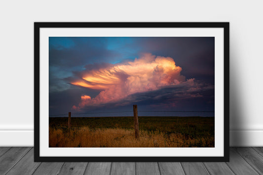 Framed and matted cloud print of a supercell thunderstorm drenched in evening sunlight over a barbed wire fence in Oklahoma by Sean Ramsey of Southern Plains Photography.