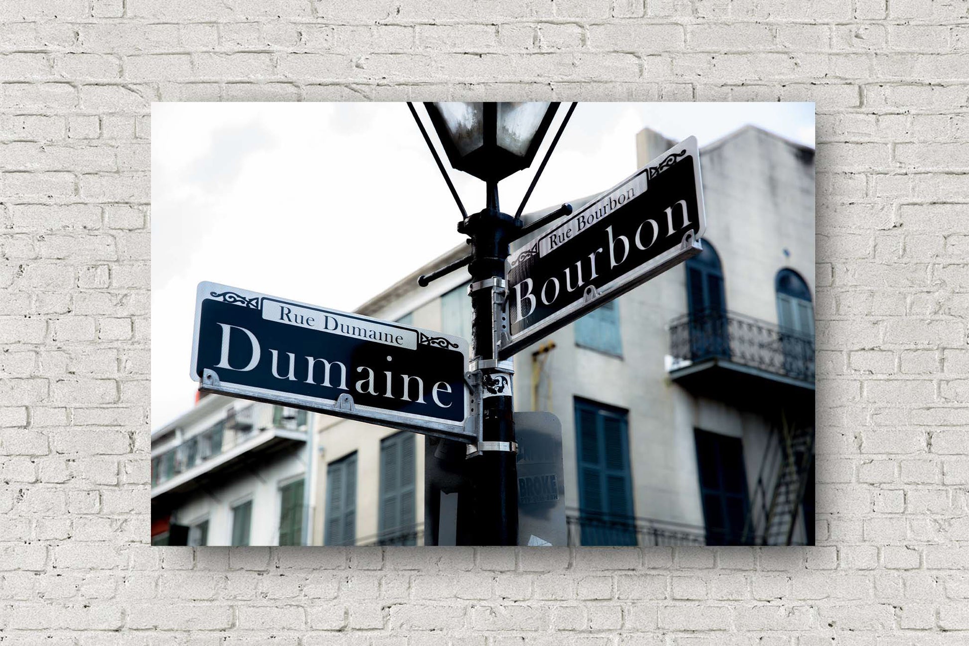 Southern metal print of street signs on a lamp post at the intersection of Dumaine and Bourbon Street in the New Orleans French Quarter by Sean Ramsey of Southern Plains Photography.