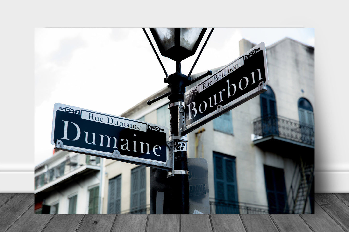 Southern metal print of street signs on a lamp post at the intersection of Dumaine and Bourbon Street in the New Orleans French Quarter by Sean Ramsey of Southern Plains Photography.
