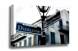 Southern canvas wall art of a street sign on a lamp post at the intersection of Dumaine and Bourbon Street in the New Orleans French Quarter by Sean Ramsey of Southern Plains Photography.