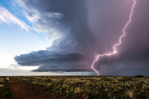 Storm photography print of a massive lightning bolt striking in front of a supercell thunderstorm over the high desert on a spring evening in New Mexico by Sean Ramsey of Southern Plains Photography.