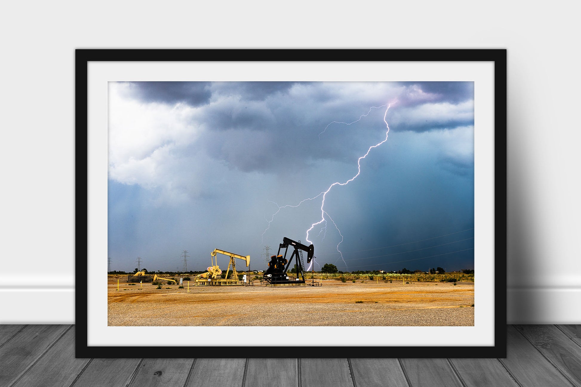 Framed and matted storm print of lightning striking behind pump jacks on a stormy summer day in the Oklahoma oilfield by Sean Ramsey of Southern Plains Photography.