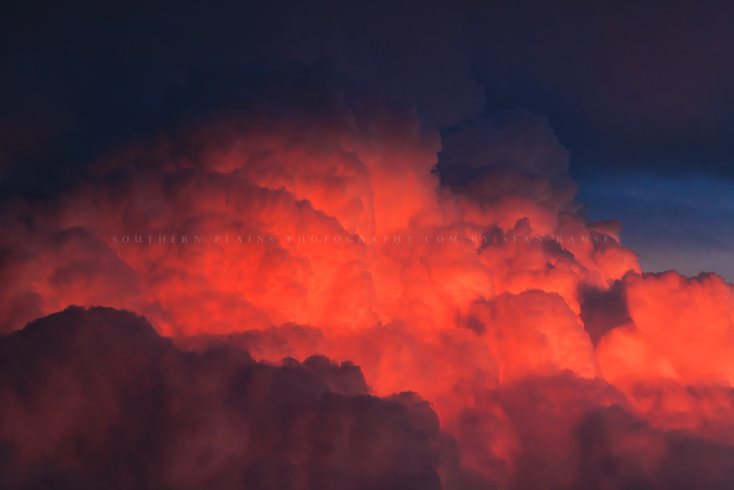 Stormy sky photography print of fiery red cumulonimbus storm clouds rising high into the sky at sunset on a stormy evening in Texas by Sean Ramsey of Southern Plains Photography.