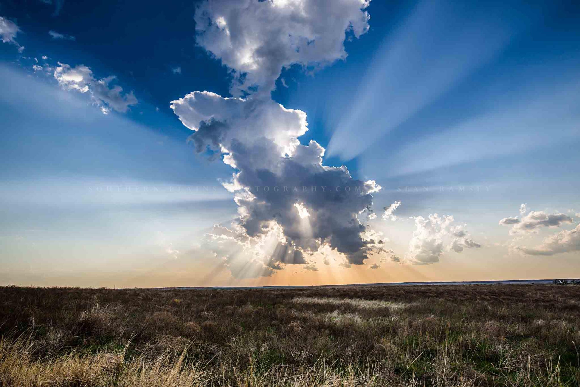 Great Plains photography print of sunbeams bursting from behind a storm cloud over open prairie on a stormy spring day in Kansas by Sean Ramsey of Southern Plains Photography.