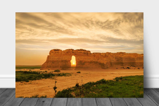 Great Plains aluminum metal print wall art of the sun setting through an opening on a stormy evening at Monument Rocks in Kansas by Sean Ramsey of Southern Plains Photography.