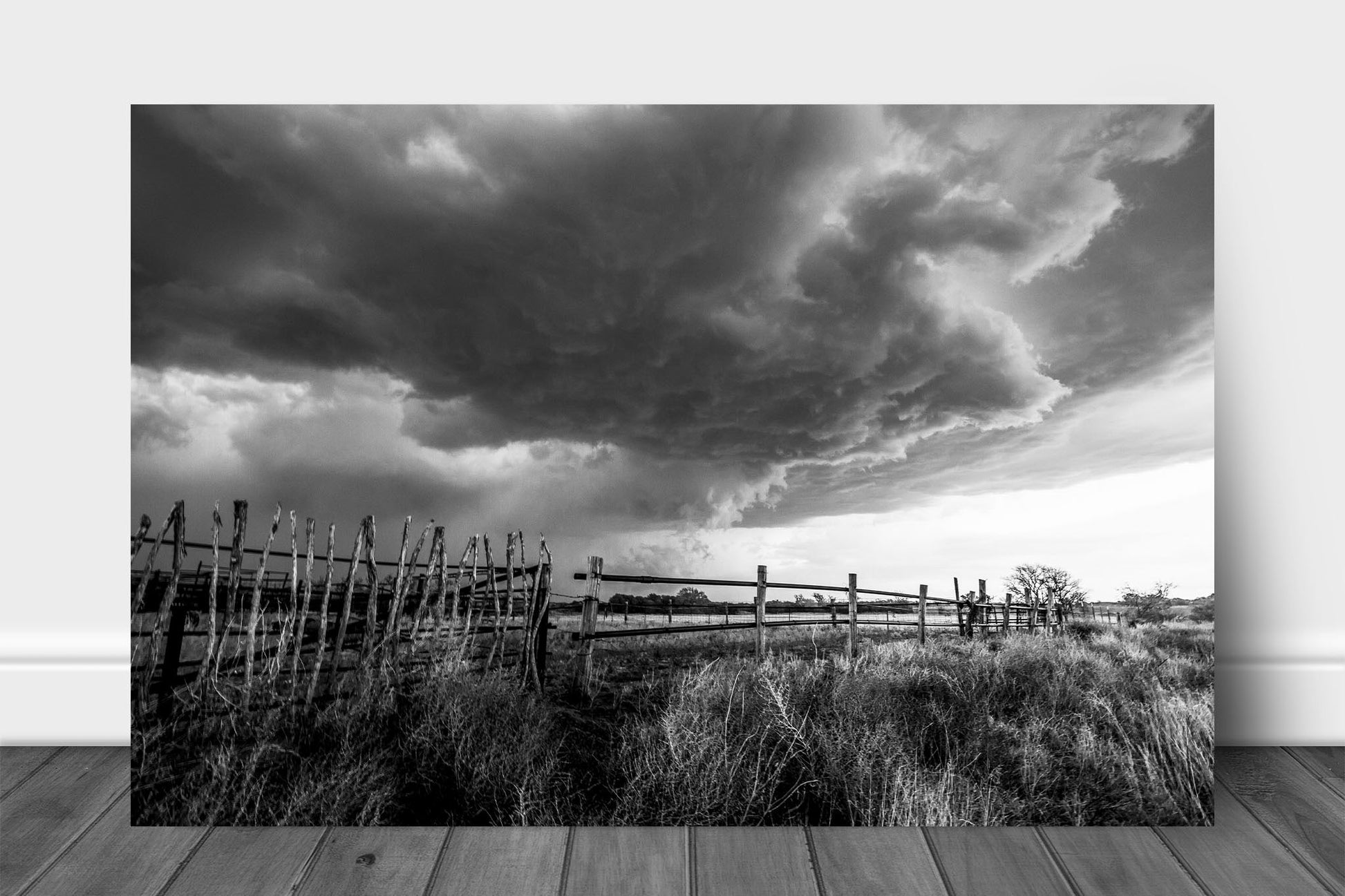 Black and white aluminum metal print wall art of a thunderstorm advancing over an old rickety fence on a ranch in western Oklahoma by Sean Ramsey of Southern Plains Photography.