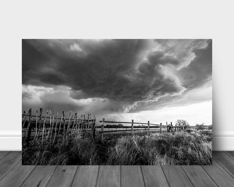 Black and white aluminum metal print wall art of a thunderstorm advancing over an old rickety fence on a ranch in western Oklahoma by Sean Ramsey of Southern Plains Photography.