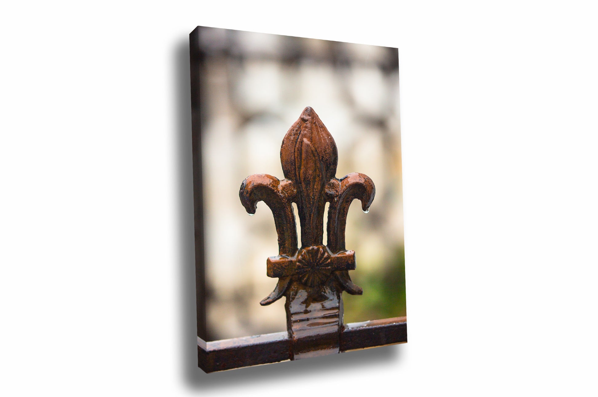 Saints canvas wall art of raindrops falling from a wrought iron Fleur de Lis along a fence on a rainy day in the New Orleans French Quarter by Sean Ramsey of Southern Plains Photography.