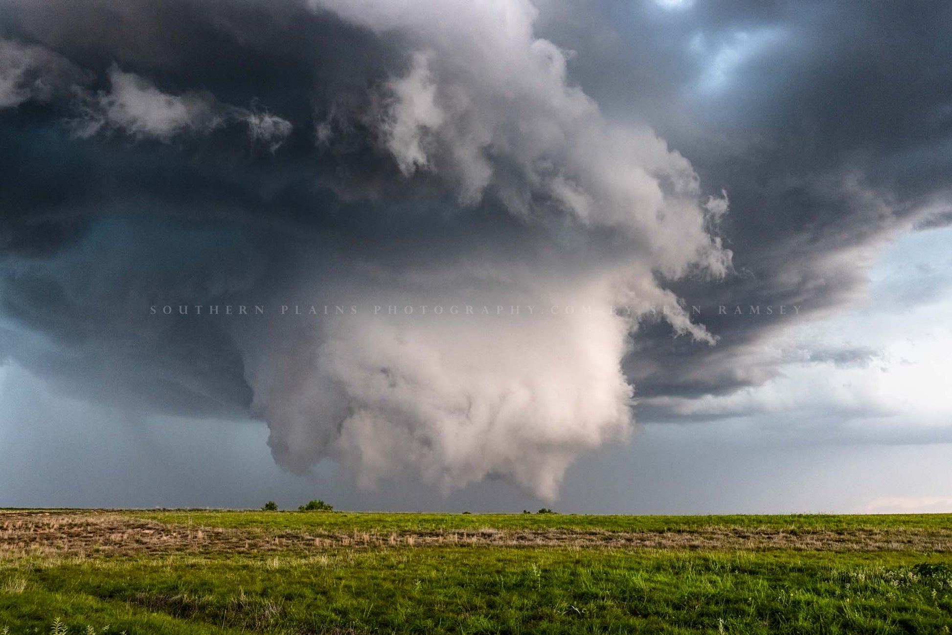 Supercell thunderstorm photography print of a wall cloud under a mesocyclone reaching for ground level on a stormy spring day on the plains of the Oklahoma panhandle by Sean Ramsey of Southern Plains Photography.