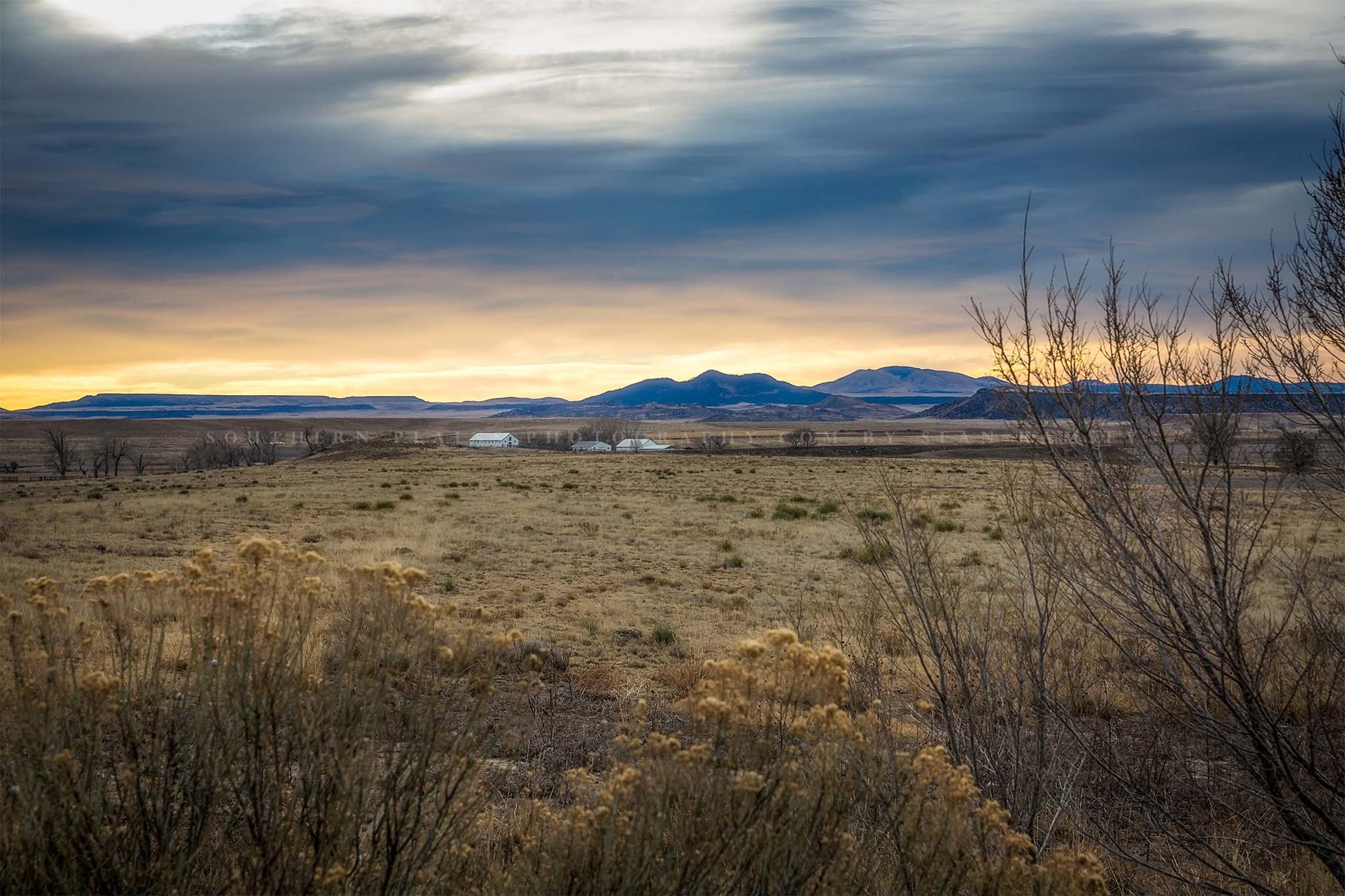 Rocky Mountains photography print of warm sunlight casting a glow over a valley on a winter morning near Raton, New Mexico by Sean Ramsey of Southern Plains Photography.