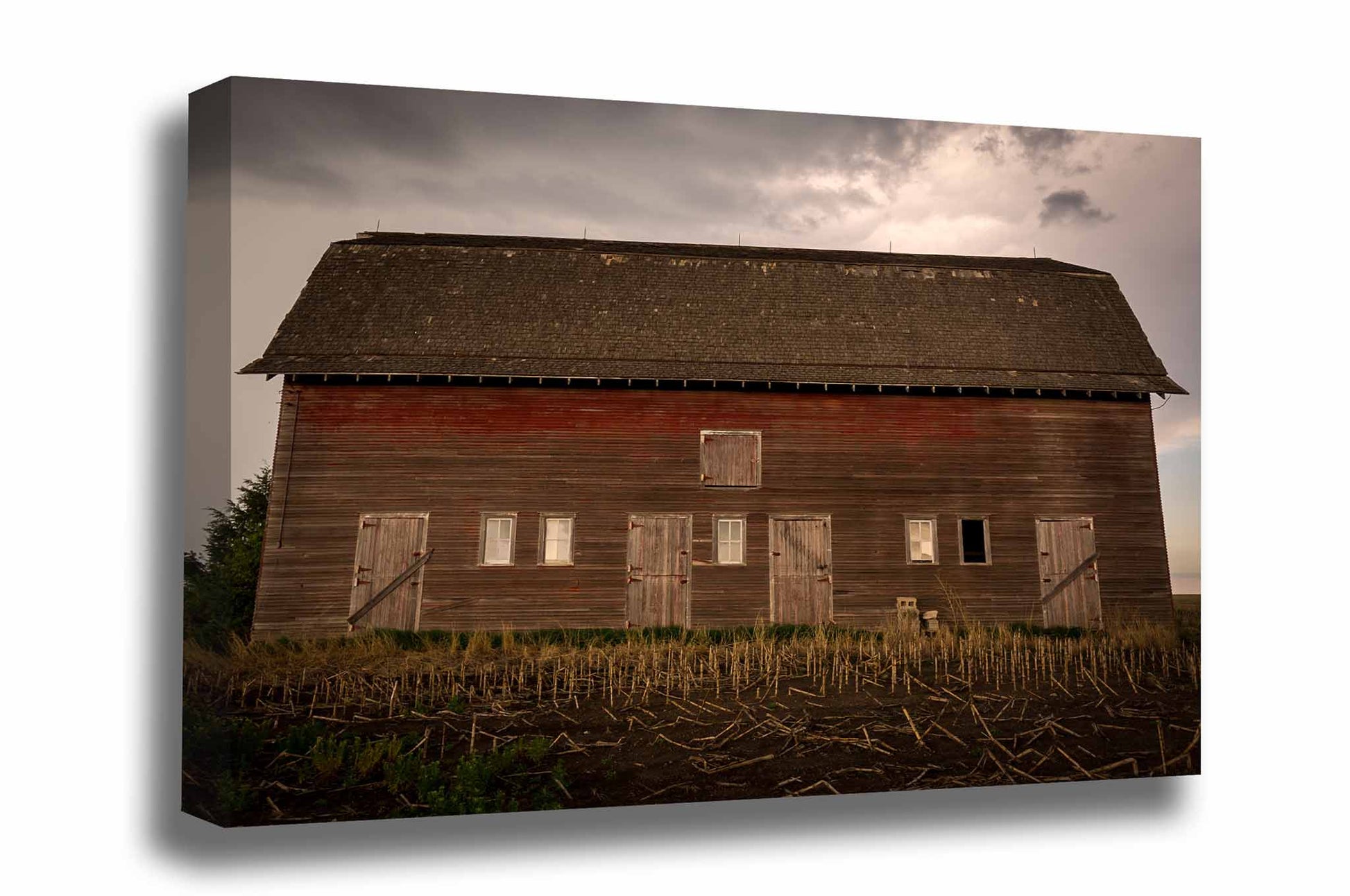 Country gallery wrapped canvas wall art of an old red barn side with multiple doors on a stormy day in Nebraska by Sean Ramsey of Southern Plains Photography.