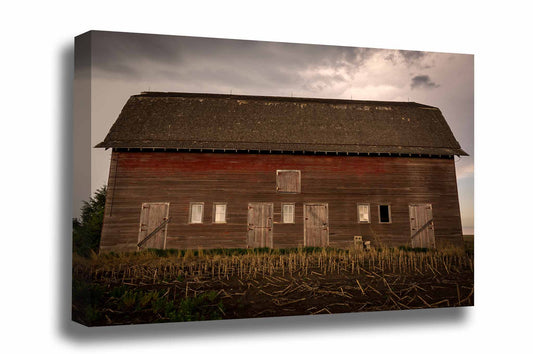 Country gallery wrapped canvas wall art of an old red barn side with multiple doors on a stormy day in Nebraska by Sean Ramsey of Southern Plains Photography.