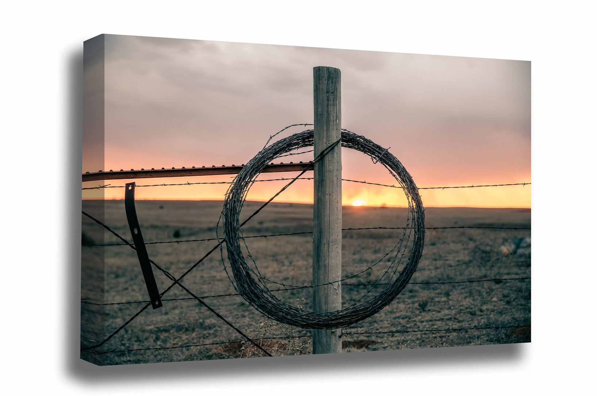 Western canvas wall art of rolled barbed wire on a fence post at sunset on a winter evening in Oklahoma by Sean Ramsey of Southern Plains Photography.
