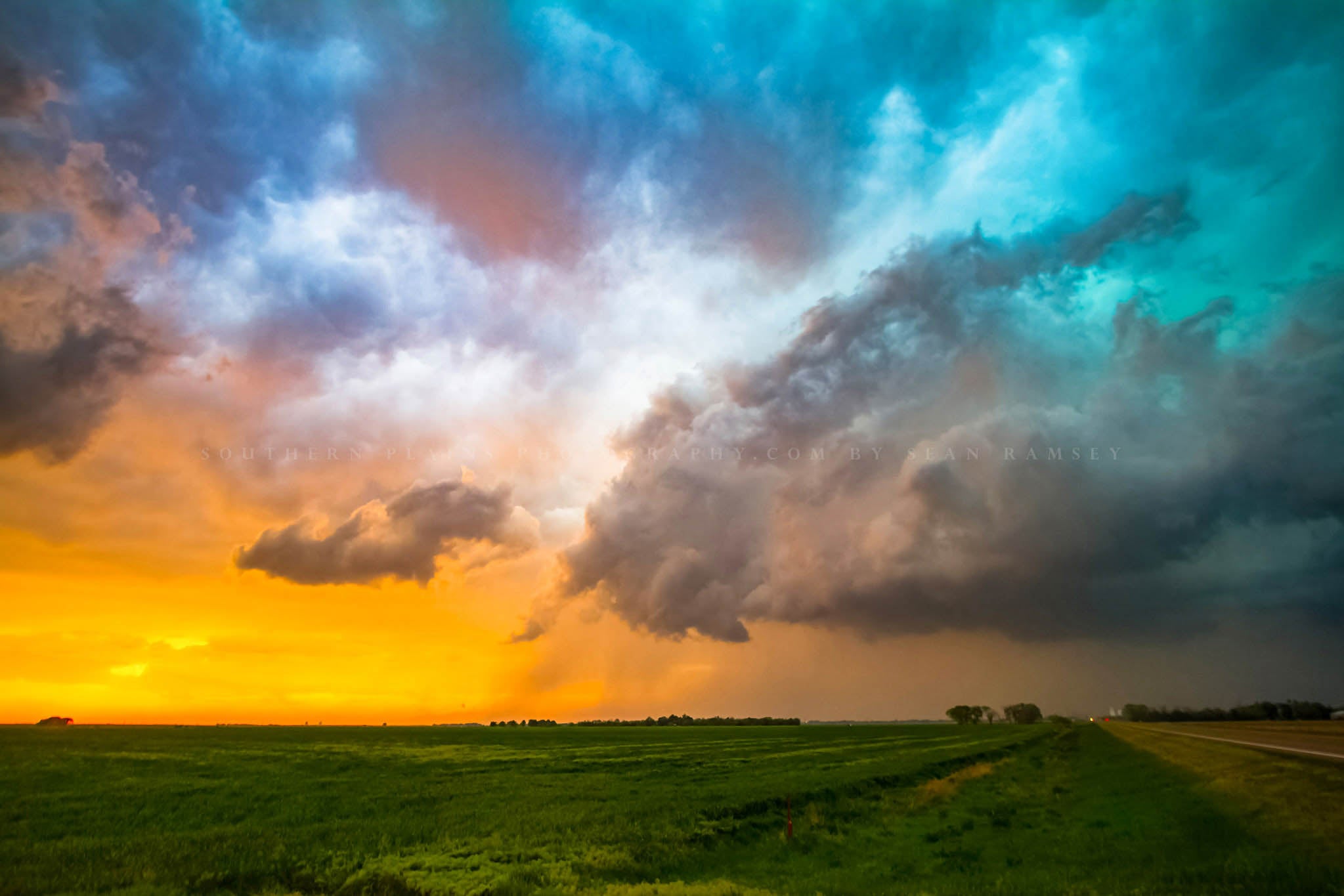 Storm photography print of colorful storm clouds over a field at sunset on a stormy spring evening in Kansas by Sean Ramsey of Southern Plains Photography.