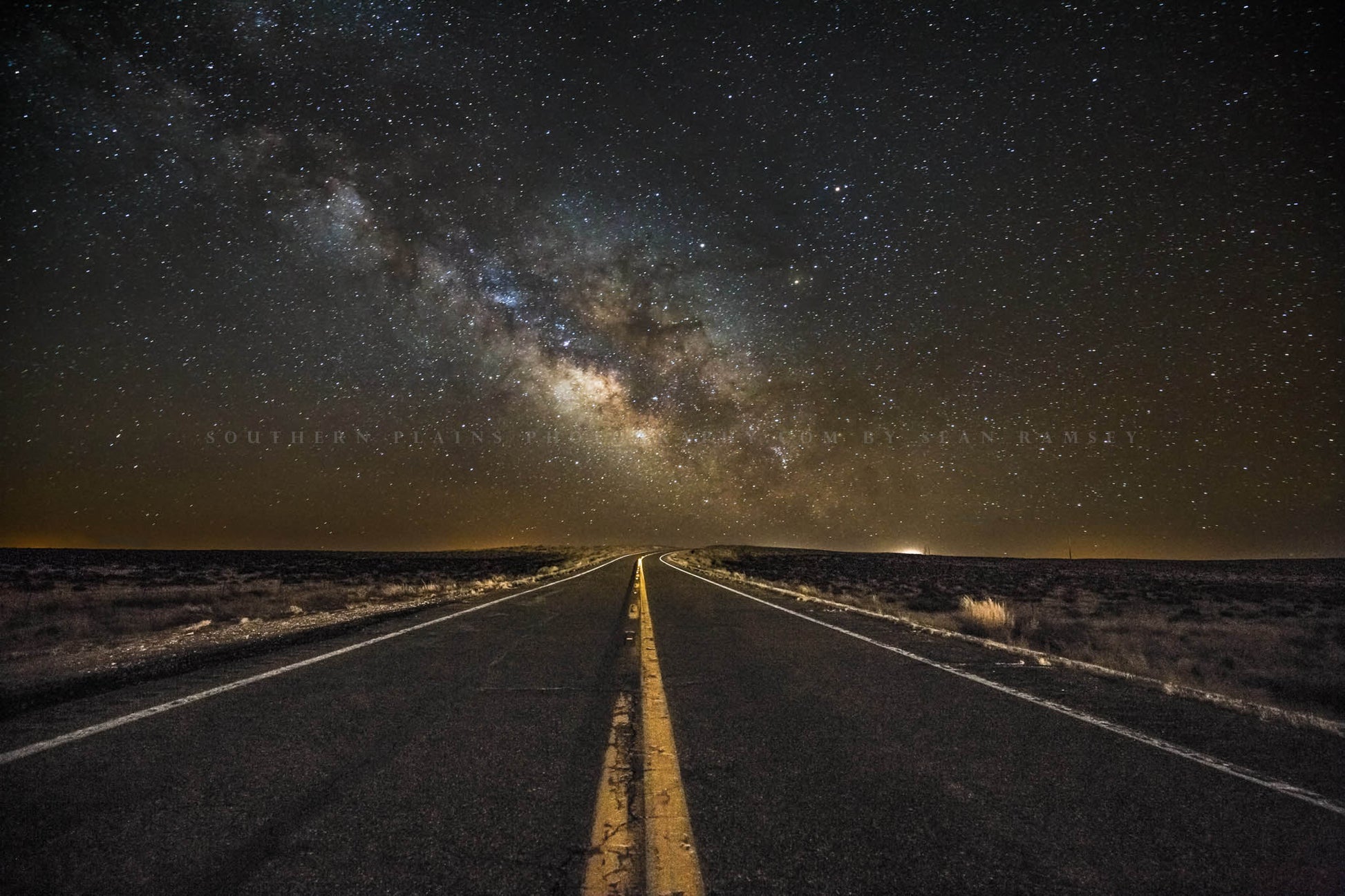 Wanderlust photography print of the Milky Way rising above a highway in the night sky on a starry night in the Arizona desert by Sean Ramsey of Southern Plains Photography.