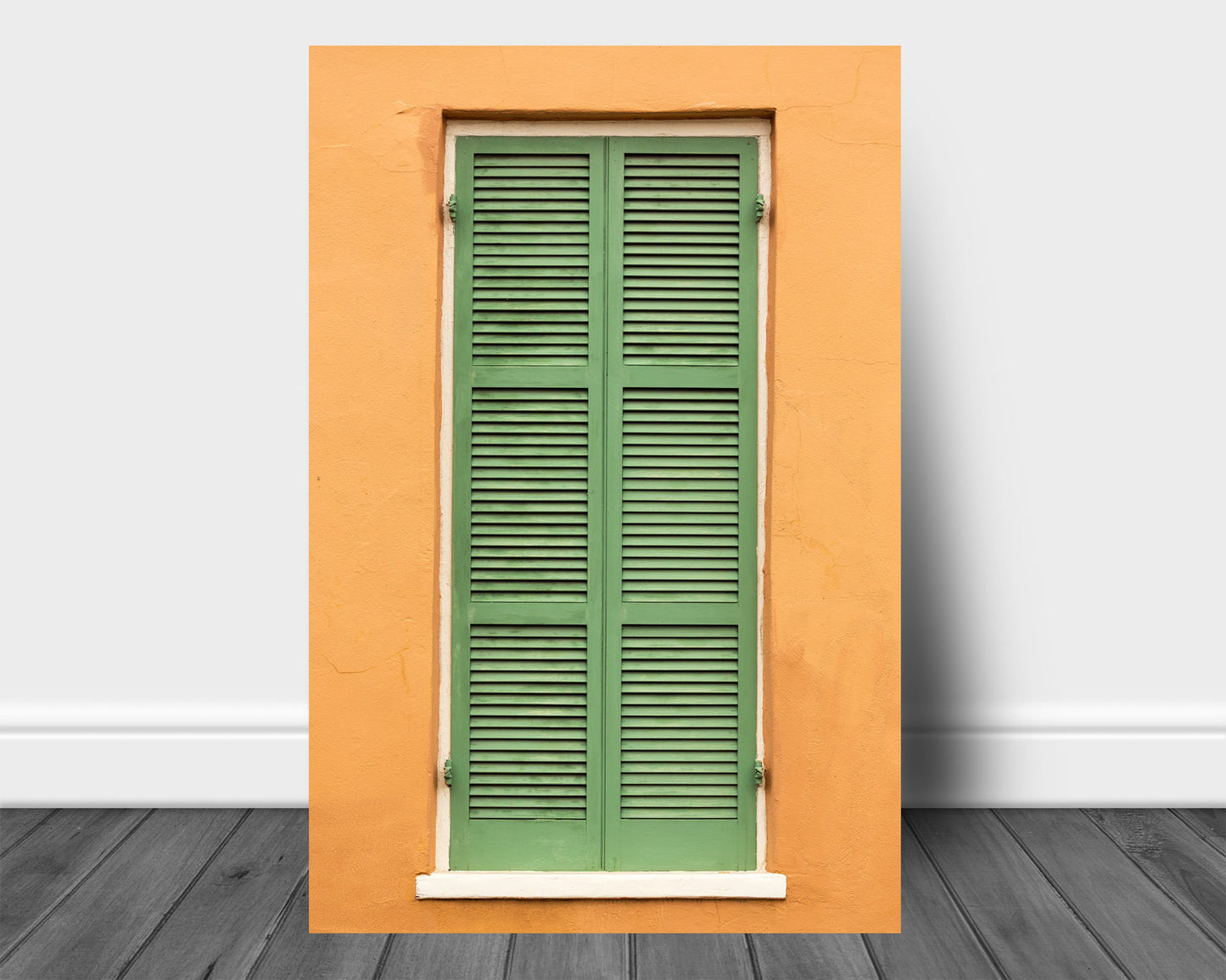 Vertical NOLA aluminum metal print wall art of green shutters against an orange wall in the French Quarter of New Orleans, Louisiana by Sean Ramsey of Southern Plains Photography.