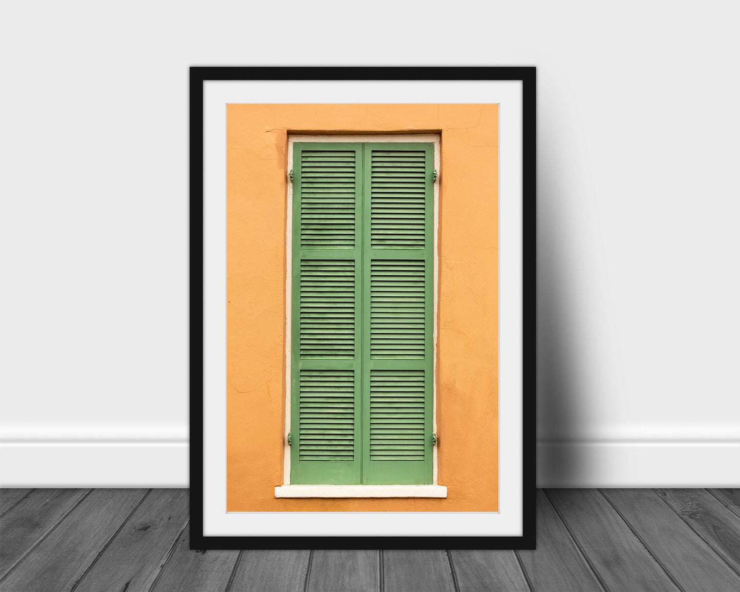 Framed and matted vertical NOLA print of green shutters against an orange wall in the French Quarter of New Orleans, Louisiana by Sean Ramsey of Southern Plains Photography.