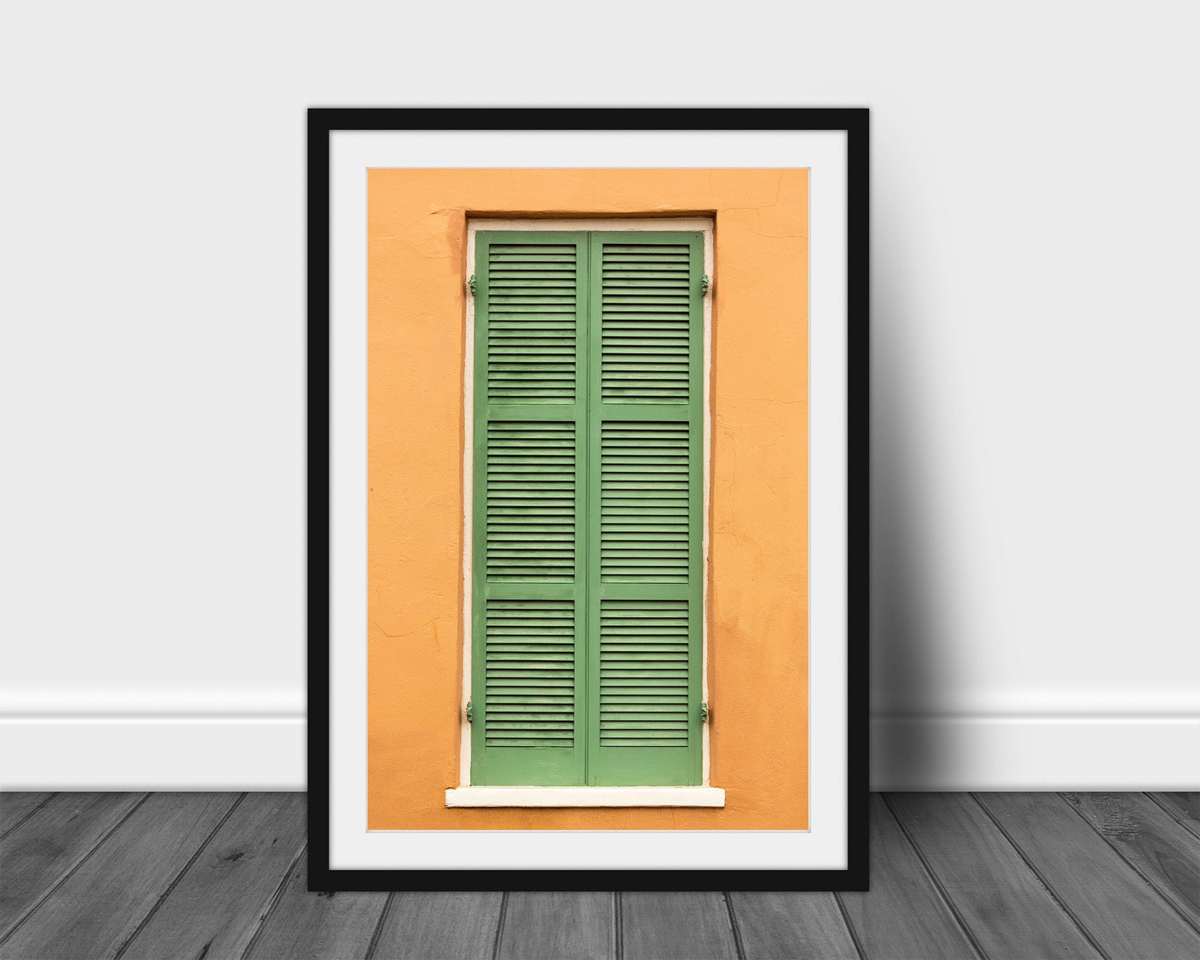 Framed and matted vertical NOLA print of green shutters against an orange wall in the French Quarter of New Orleans, Louisiana by Sean Ramsey of Southern Plains Photography.