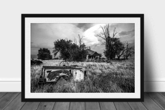 Framed black and white country print of a rusted pickup bed in the front yard of an abandoned house in Oklahoma by Sean Ramsey of Southern Plains Photography.