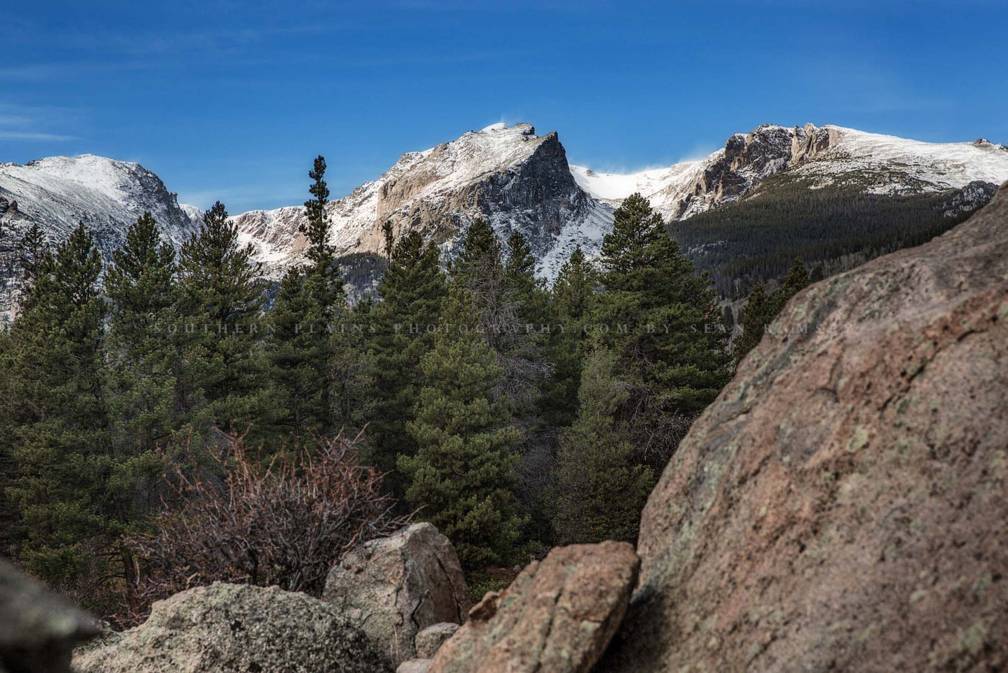 Western landscape photography print of Hallett Peak overlooking pine trees and boulders on an autumn day in Rocky Mountain National Park, Colorado by Sean Ramsey of Southern Plains Photography.