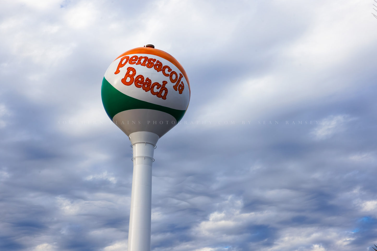 Travel photography print of the Pensacola Beach water tower against a moody sky along the Gulf Coast of Florida by Sean Ramsey of Southern Plains Photography.
