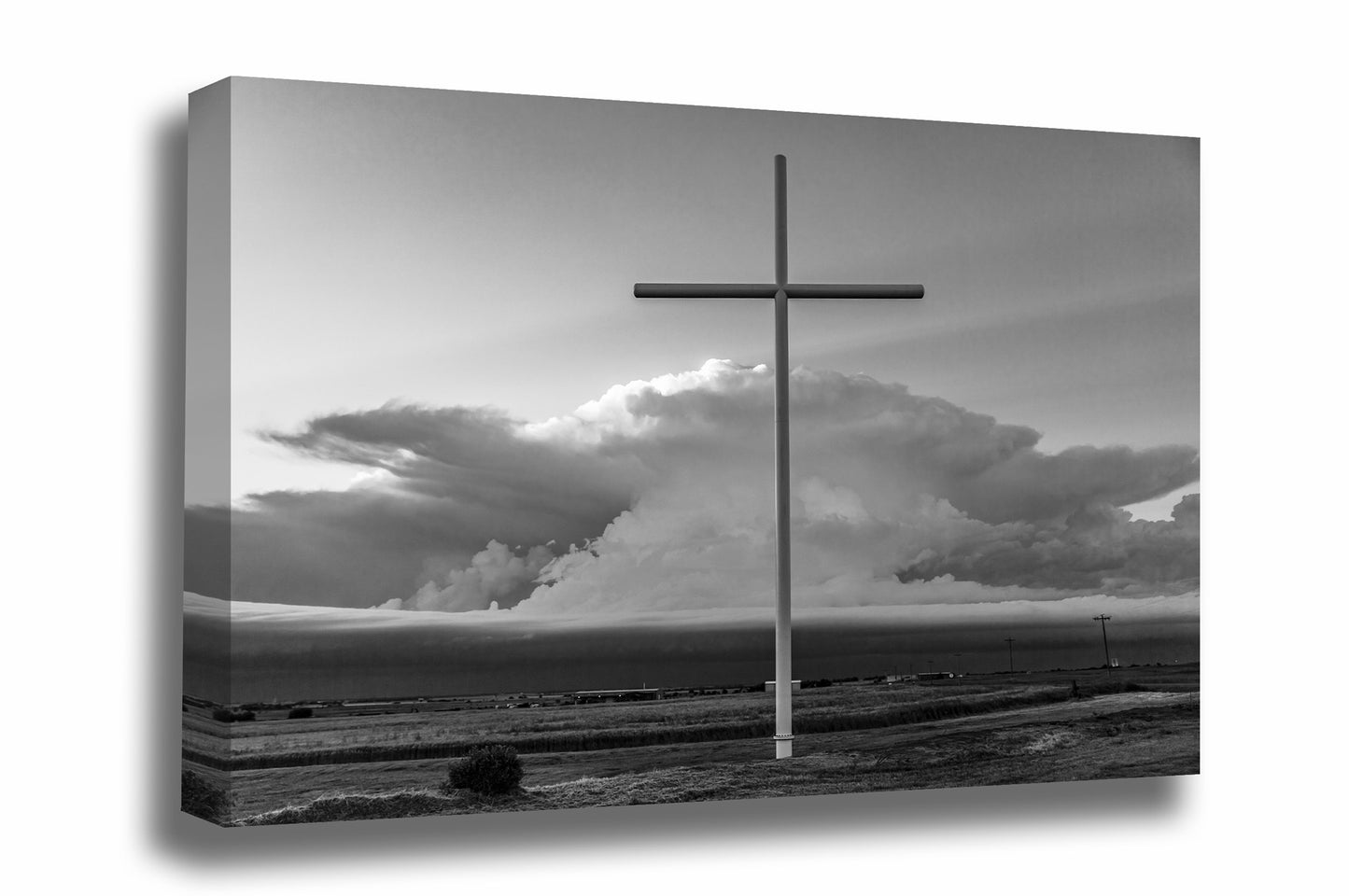 Spiritual canvas wall art in black and white of a large cross in front of a supercell thunderstorm on a stormy day in Oklahoma by Sean Ramsey of Southern Plains Photography.