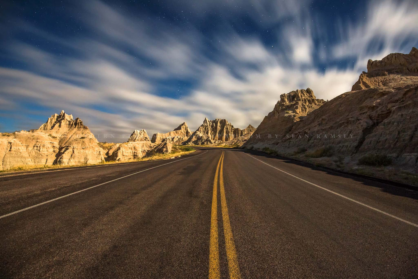 Road trip photography print of a highway leading through Badlands National Park, South Dakota by Sean Ramsey of Southern Plains Photography.