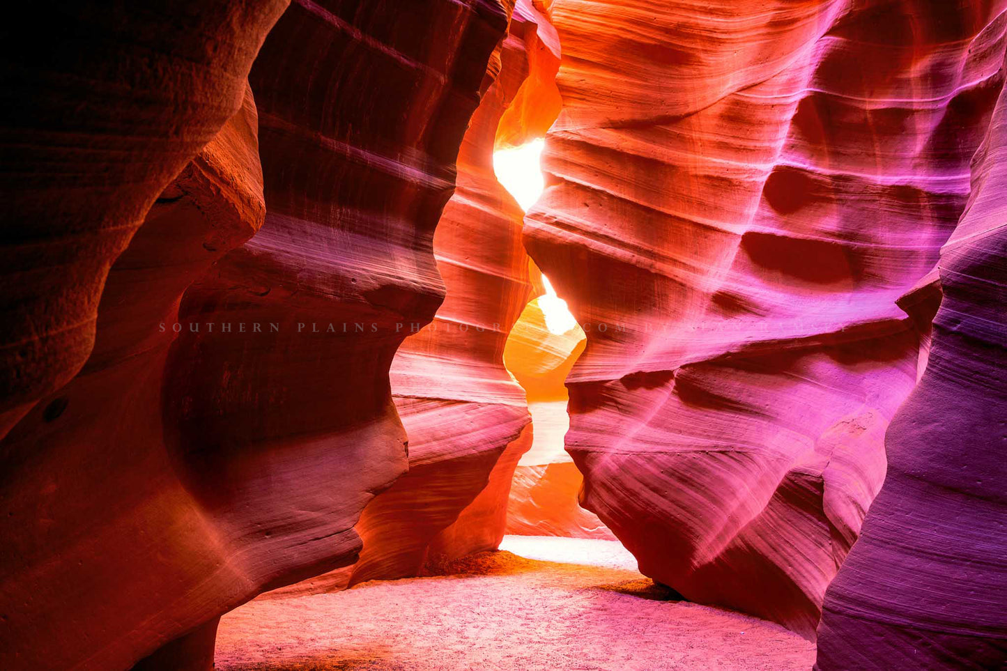 Desert southwest photography print of Antelope Canyon walls shaped as an hourglass leading to sunlight in Arizona by Sean Ramsey of Southern Plains Photography.